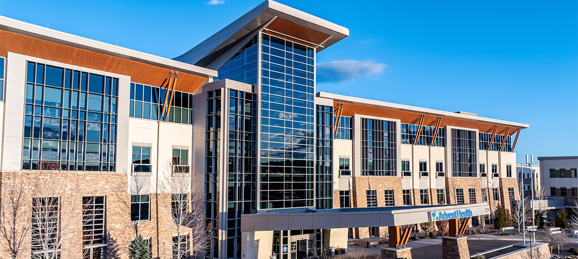 Exterior view of AdventHealth Castle Rock hospital, a large medical building with a large windows.